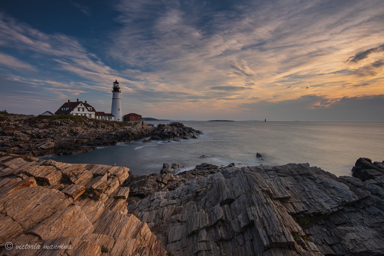 Lighthouse and keeper's house on rocky coast